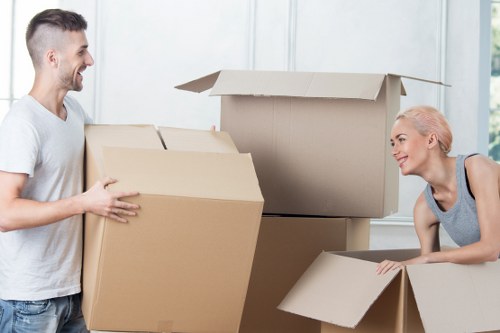 Family moving house in Sutton with packed boxes and furniture