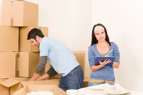 Local movers handling furniture in a Sutton residential street