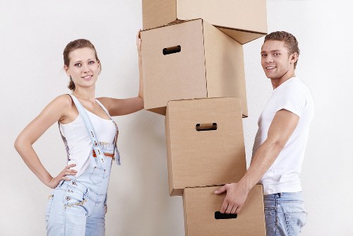 Moving furniture through a flat staircase in Sutton with protection equipment
